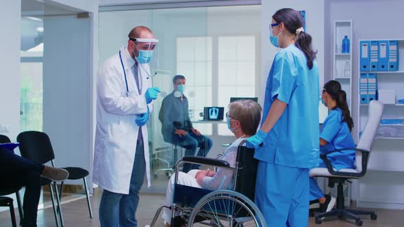 Discussing with Disabled Senior Woman During COVID Pandemic alt