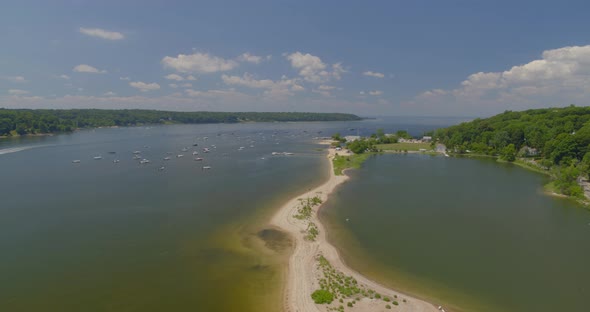 Flying Towards Cold Spring Beach and Boats Anchored on Harbor in Long Island alt
