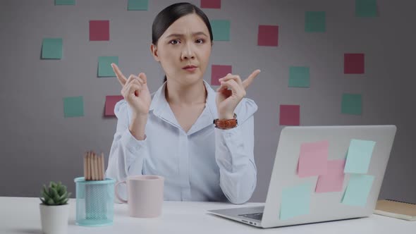 Asian woman feel confused working on a laptop at home office