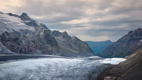 aerial travelling on a swiss glacier in the swiss alps on a cloudy sunset alt