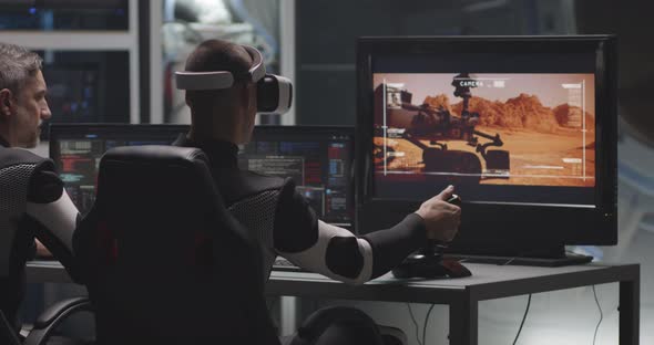 Man Controlling Mars Rover with Remote Controller alt