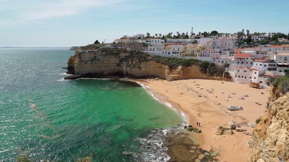 Beautiful View of the Portuguese Carvoeiro Beach in Summer with Clear Sea and Sunbathing Tourists alt