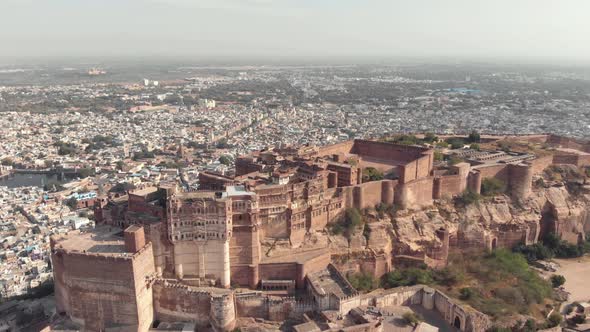 Fly over Mehrangarh fort overseeing the city of Jodhpur, Rajasthan, India alt