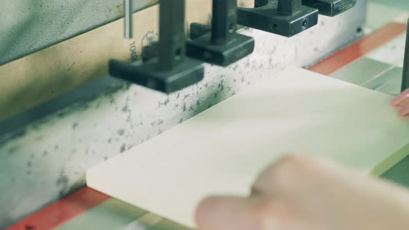 Factory Mechanism Is Punching Holes in Paper alt