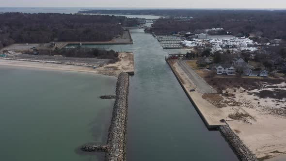 An aerial view over the Shinnecock Canal in Hampton Bays, Long Island, NY. The drone camera dolly in alt