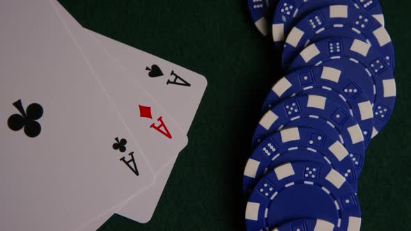 Rotating shot of poker cards and poker chips on a green felt surface - POKER 052 alt