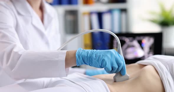 Doctor Conducts Ultrasound Examination of Internal Organs in Clinic alt