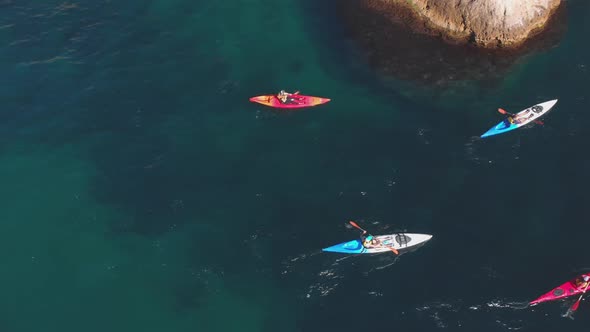 Aerial Shot Group of Kayakers Paddling Down on Mountain River on Kayaks on Summer Day alt