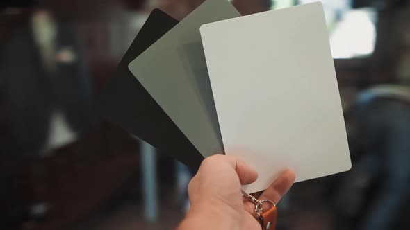 Photographer Uses Cards to Adjust Camera in Restaurant alt