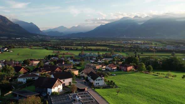 Aerial View of Liechtenstein with Houses on Green Fields in Alps Mountain Valley alt