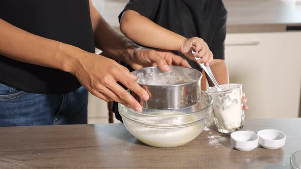 Closeup of Woman and Child Hands in the Kitchen alt