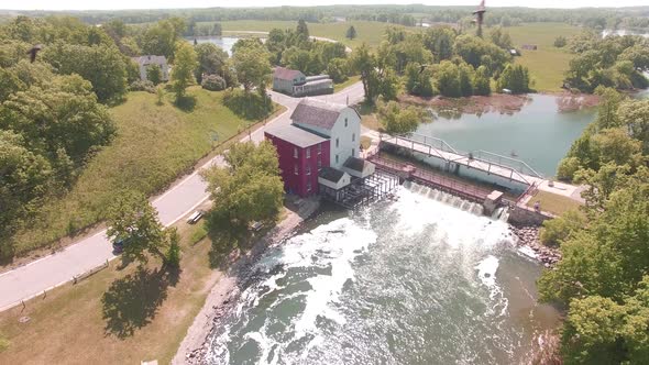Aerial shot of a mill and river dam alt