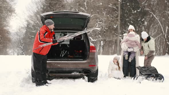 Family in Winter Forest with Kids on Weekend alt