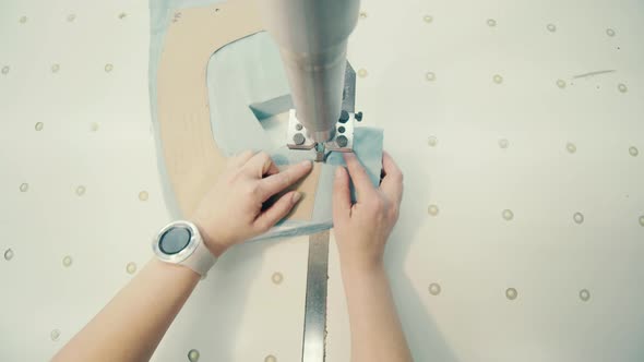 Textile Worker is Cutting Out a Fabric Pattern alt