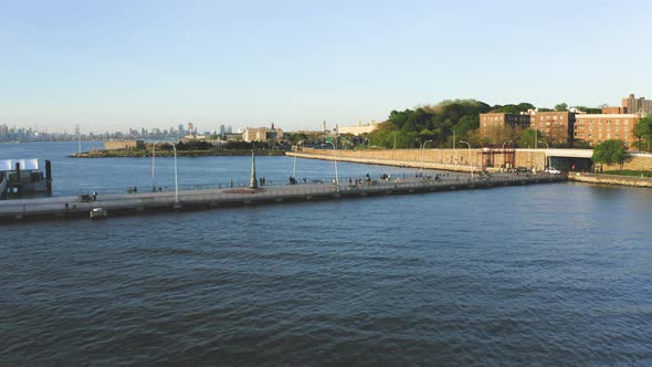 Aerial Shot of a Pier Next to an Urban Neighborhood with New York Skyline (Bay Ridge, Brooklyn, NY) alt
