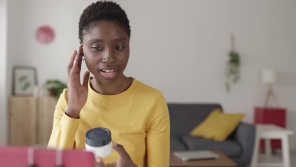 Female Blogger Recording a Video While Sitting in the Living Room at Home alt