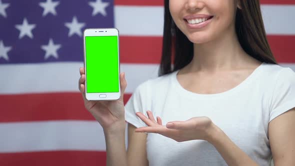 Smartphone With Green Screen in Female Hands, USA Flag Background, Application alt