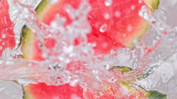Super Slow Motion Shot of Melon Slices Falling Into Water Whirl at 1000 Fps alt