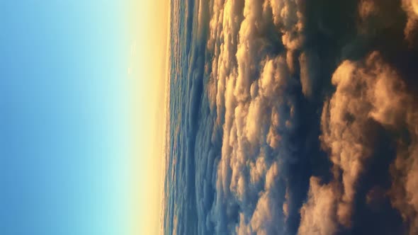 Vertical Video of Fast Fluffy Cotton Clouds at Amazing Sunset Aerial View From the Plane alt