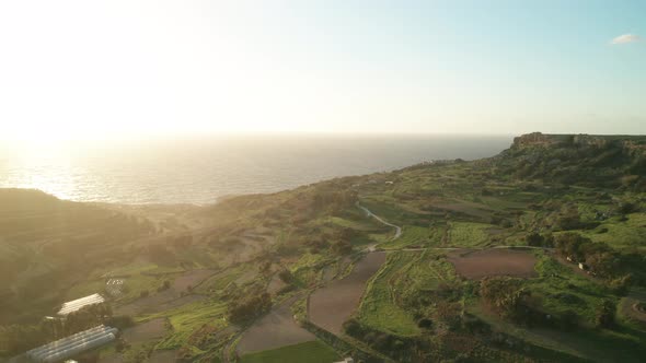AERIAL: Farms Near Coastline of Malta During Winter on a Very Sunny Golden Hour Evening