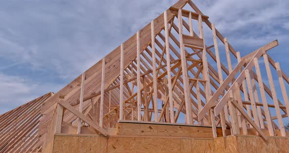 Framing Beams of New Home Under Construction Wooden Roof Trusses alt