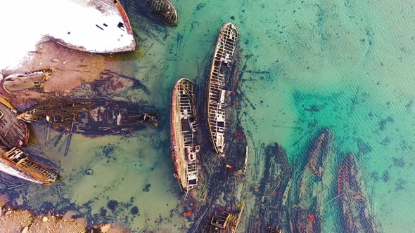 Old sunken ships near coast in winter alt