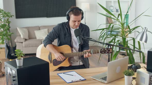 An Influential Musician With a Guitar Writes Music at Home Music Studio Spbd alt