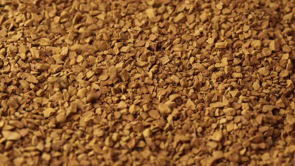 Granules of Instant Coffee Sprinkled on a Plate Closeup Spinning As a Backdground for a Coffee Shop alt