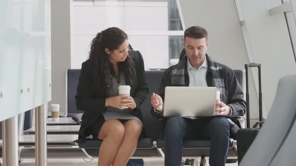 Businessman and businesswoman meeting at airport