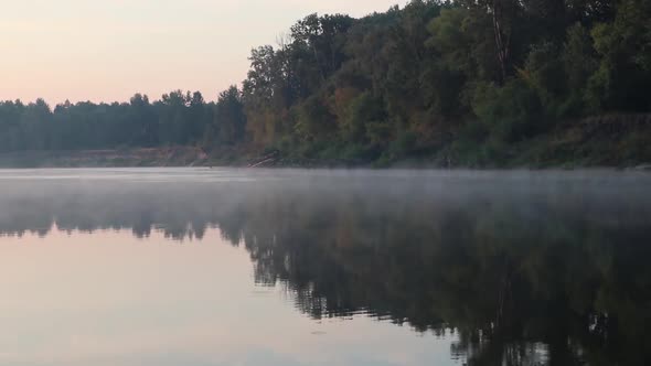Beautiful calm sunrise dawn on river, magic mist