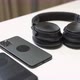 close up video of two dark smartphone and headphones on a white table - VideoHive Item for Sale
