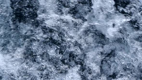Seamless loop in slow motion of foam water full of bubbles. Ocean, sea or hot tub.