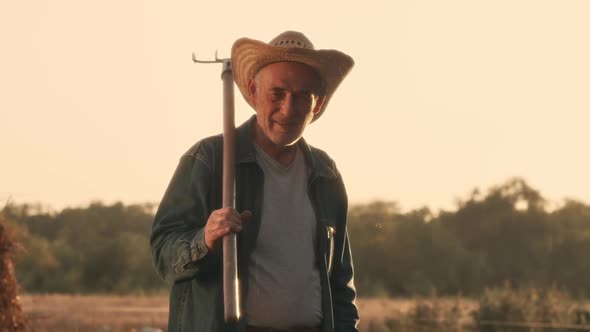 Farmer with Pitchfork in Field alt