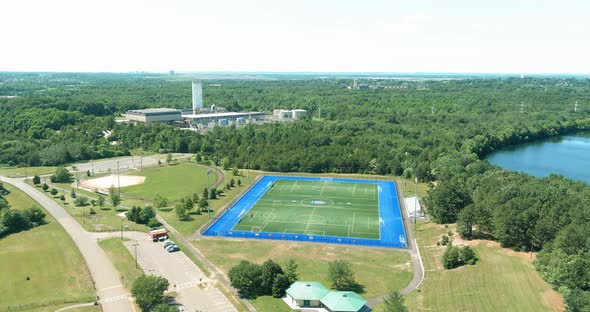 Aerial panoramic top view of soccer green grass field in public park alt
