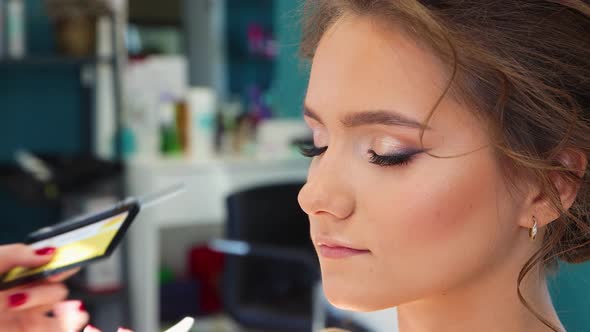 The Master Gently Glues the Eyelash to the Girl's Eye in the Beauty Salon alt