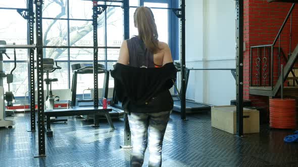 Young Fit Woman Entering a Fitness Club and Preparing for the Training