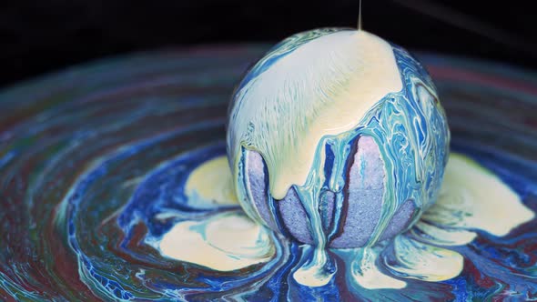 Paint Flows Down the Surface of the Texture Ball and Spreads Over the Table alt