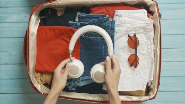 A Traveler Woman is Getting Ready for Travel and Packing Clothes alt