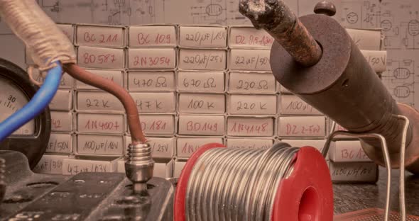 Retro electronics workshop with parts and voltmeter. Parallax effect.