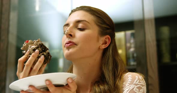 Business woman eating a chocolate cake 4k alt