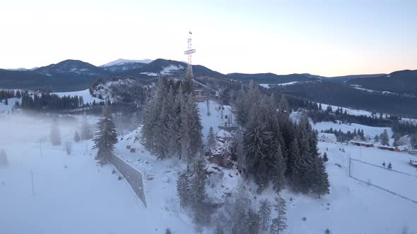 Aerial view of a cross on a cliff at Piatra Fantanele alt