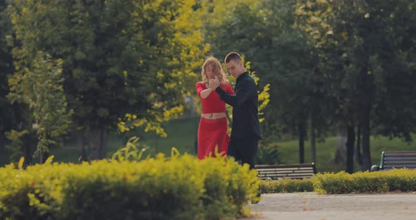 Romantic Dance in Pair Elegant Man Dancing with a Beautiful Woman in Red