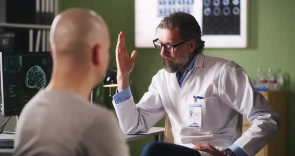 Oncology Patient Reacting To Bad News From Doctor alt