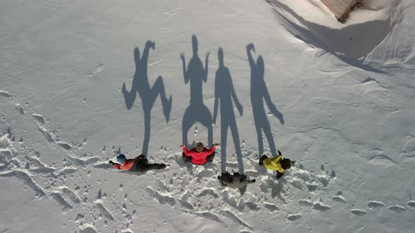 Aerial View of Four Large Shadows in the Snow