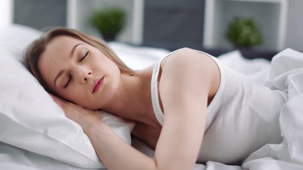 Attractive Female Enjoying Sleep Lying in Comfy Fresh Bed alt