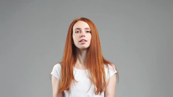 Beautiful Girl Tries To Choose Orange or Apple. Healthy Food Selection Concept. Slow Motion alt