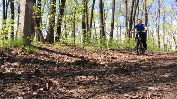 Boy Riding Fast a Bike In The Woods. 