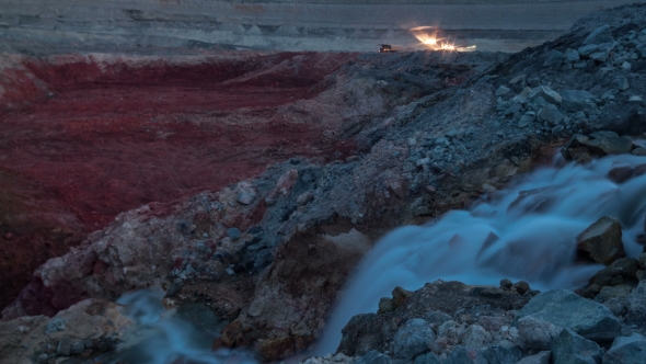 . Industrial Waterfall. Sunset. Drag-line Excavator Loads Ore Into Dump-track. alt