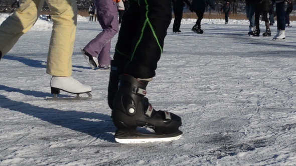 People Legs Skate Slide On Frozen Lake Ice In Cold Winter Day