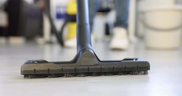 Employee of Cleaning Company Vacuums Floor in Office  Movie alt